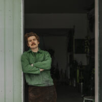 Portrait of blacksmith standing in entrance to workshop